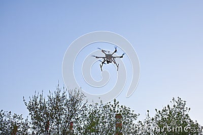 Multicopter is flying in blue sky Stock Photo