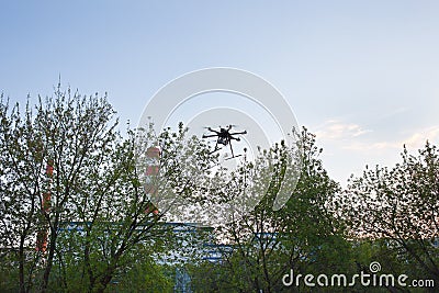 Multicopter is flying in blue sky Stock Photo