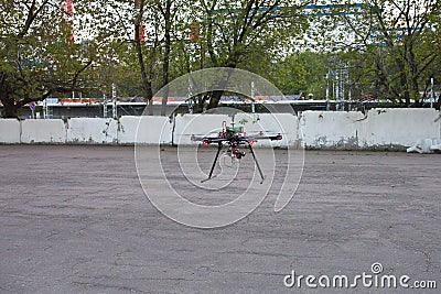 Multicopter is landing to the ground Stock Photo