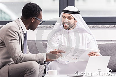 Multicultural businessmen talking and smiling Stock Photo