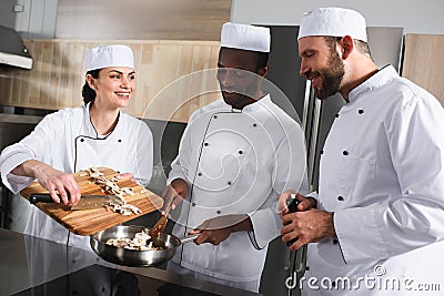 multicultural chefs preparing mushrooms Stock Photo