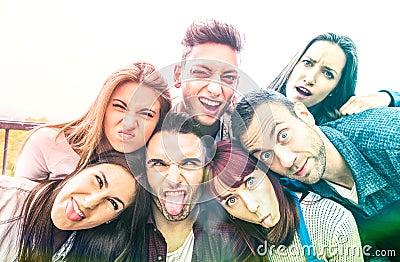 Multicultural millenial friends taking selfie with funny faces - Happy youth friendship concept with millennial young trends Stock Photo