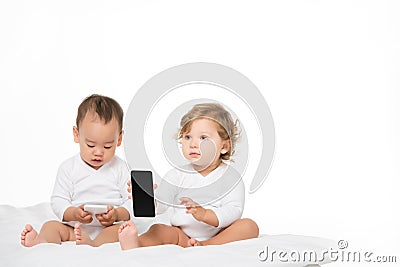 multicultural toddlers with digital smartphones Stock Photo