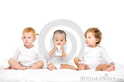 multicultural toddlers with smartphone sitting in row Stock Photo