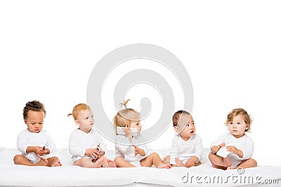 cute multicultural toddlers holding smartphones Stock Photo