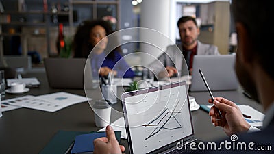 Multiethnic businesspeople discuss chart graph using computer on conference meet Stock Photo