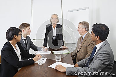 Multiethnic businesspeople at meeting in conference room Stock Photo