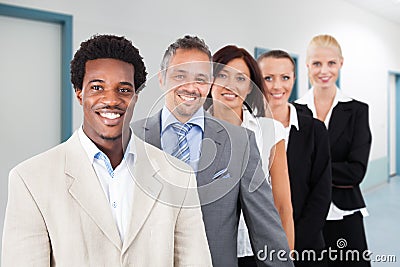 Multiethnic businesspeople smiling at office Stock Photo