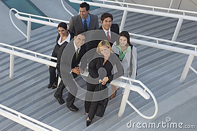 Multiethnic Businesspeople On Stairs Stock Photo