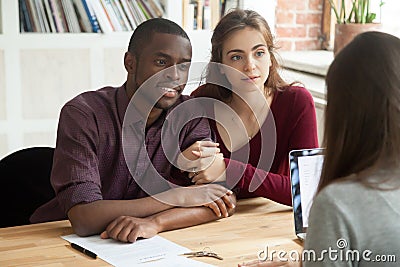 Multiethnic couple considering mortgage investment real estate p Stock Photo