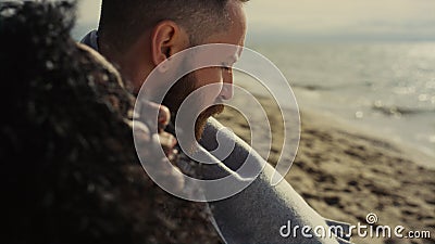 Multiethnic couple looking beach. Thoughtful people relaxing at sea outdoors. Stock Photo