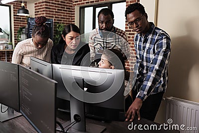 Multiethnic cyber security team developing software algorithm for information processing Stock Photo