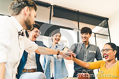 Multiethnic diverse group of happy colleagues join hands together. Creative team, casual business coworker, or college students Stock Photo