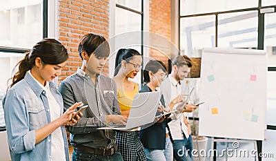 Multiethnic diverse group of happy young adult using information technology gadget devices together. Modern lifestyle concept Stock Photo