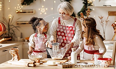 Multiethnic family, grandmother and two little kids, cooking Christmas cookies together in kitchen Stock Photo