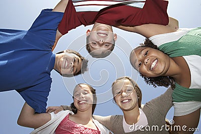 Multiethnic Friends Forming Huddle Stock Photo