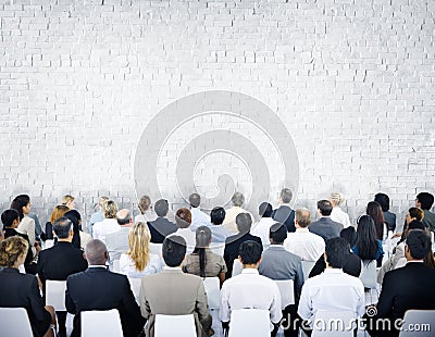 Multiethnic Group of Audiences with Brick Wall Stock Photo