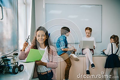 multiethnic group of little kids working together Stock Photo