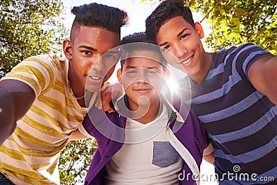 Multiethnic Group Of Teenagers Embracing Smiling At Camera Stock Photo