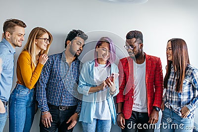 Multiethnic Group of Young People in Casual Wear isolated over grey background Stock Photo