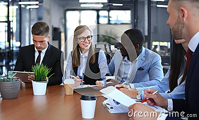 Multiethnic group of young people putting their hands on top of each other. Close up image of young business people Stock Photo
