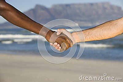 Multiethnic Handshake At Table Mountain Beach Stock Photo