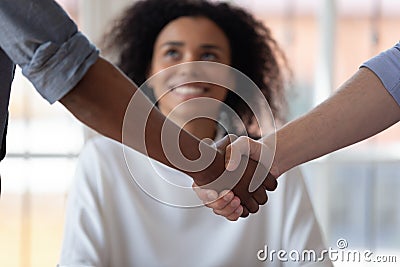 Multiethnic male partners handshake closing deal in office Stock Photo