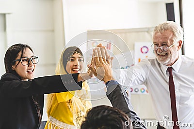 Multiethnic office worker doing high touch hands celebration after project work done Stock Photo