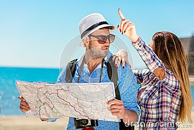 Multiethnic traveler couple using generic local map together on sunny day. Stock Photo