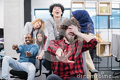 Multiethnics business team racing on office chairs Stock Photo