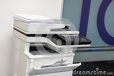 Multifunctional office laser printer with white paper stack for use in scanning and printing documents in workplace Stock Photo