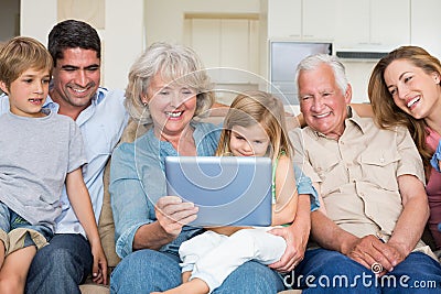 Multigeneration family using digital tablet Stock Photo