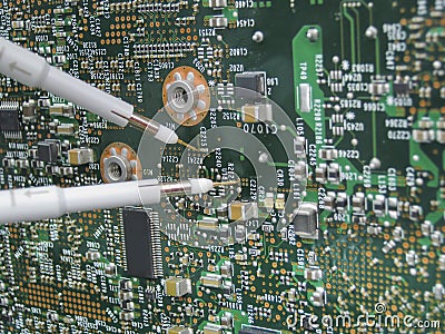 Multimeter probes examining a circuit board Stock Photo