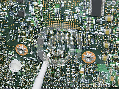Multimeter probes examining a circuit board Stock Photo