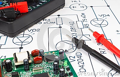 Multimeter probes examining a computer circuit board Stock Photo