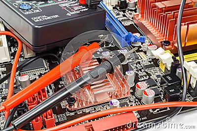 Multimeter probes on the motherboard surface closeup Stock Photo