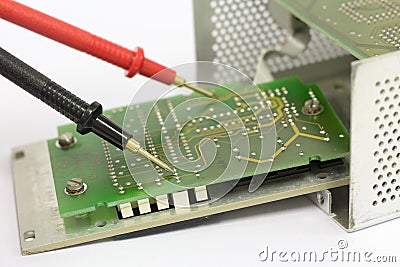 Multimeter probes on printed circuit board. Stock Photo