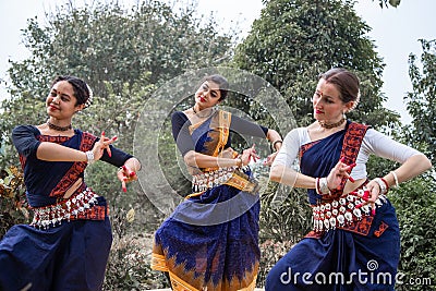 Multinational group of beautiful young classical odissi dancers wears traditional costume and posing Odissi dance mudra in the Stock Photo