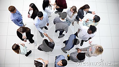 multinational office workers and foreign employees stand and talk in the office lobby.Top view. Stock Photo
