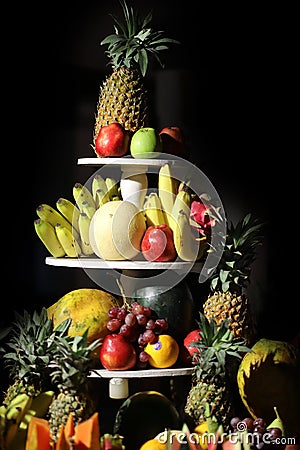 Multiple fruits kept on a step table Stock Photo