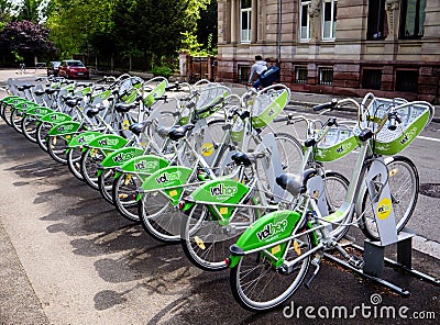 Multiple bikes to rent available from the automatic Velhop service Editorial Stock Photo