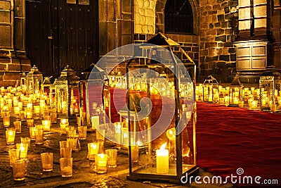 Multiple candles on the floor inside the church. Stock Photo