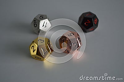 Multiple d12 twelve sided dice die copper silver gold black Stock Photo