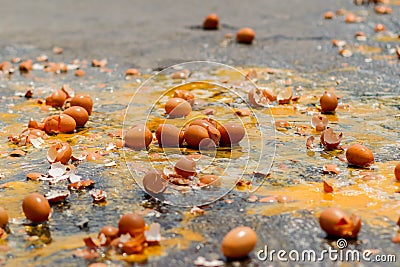 Multiple eggs crashed on the road due to an accident in an egg delivery truck that was about to deliver eggs to restaurants in the Stock Photo