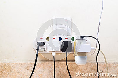 Multiple electricity plugs attached to multi adapter is dangerou Stock Photo