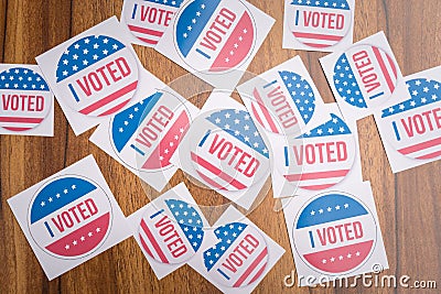 Multiple I Voted stickers on table - concept of voter fraud showing many I voted stickers. Stock Photo