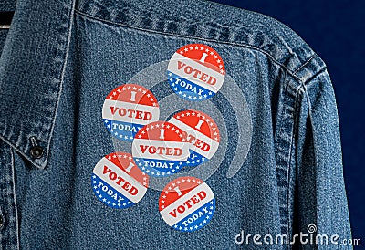 Blue denim working clothing with many Voted stickers on dark background Stock Photo