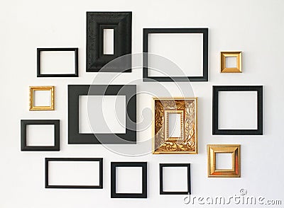 Multiple many blank small picture frames on white wall Stock Photo