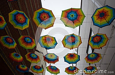 Beautiful colorful umbrellas hanging on the wire Stock Photo