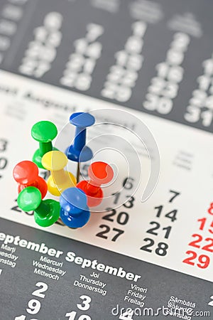 Multiple pins on a calendar suggesting busy day or schedule Stock Photo